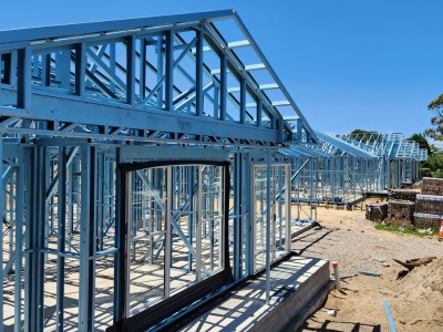 Steel frame of a family house with roof trusses under construction